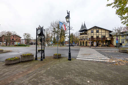 Ciechocinek, kujawsko-pomorskie / Poland - November, 17, 2020: Center of a small holiday resort. Old tenement houses and road intersection. Autumn season.のeditorial素材