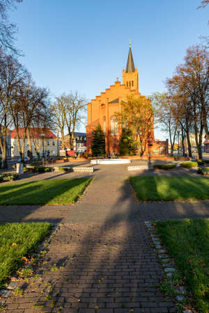 Jastrowie, wielkopolskie / Poland - November, 20, 2020: Old Catholic Church in the center of a small town. Brick Christian temple. Autumn season.のeditorial素材