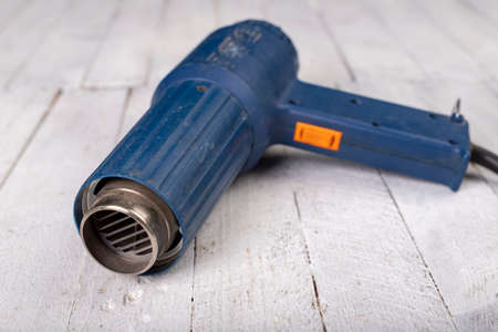 Heat gun for removing old paint. Accessories for small work in the workshop. Dark background.の写真素材