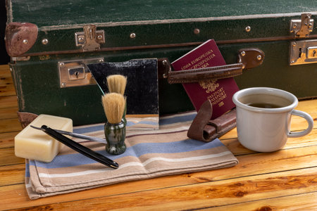 Razor, beard brush and suitcase. Personal care accessories for men on the go. Dark background.の写真素材