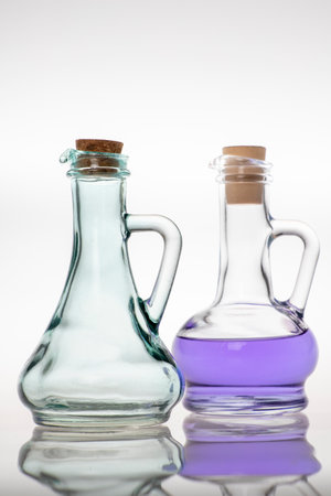 Glass bottles for storing cooking oil. Container used in the home kitchen. Light background.の写真素材