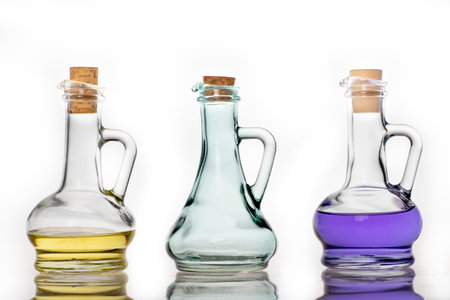 Glass bottles for storing cooking oil. Container used in the home kitchen. Light background.の写真素材