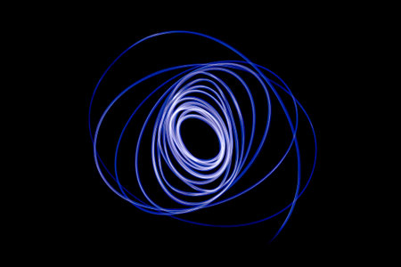 Light streaks in the shape of circles. A trace of a moving light point. Dark background.の写真素材