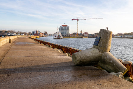 Darlowko, West Pomeranian Voivodeship Poland - December, 17, 2020: Breakwater and entrance to a small fishing port. Port locations in Central Europe. Autumn season.のeditorial素材