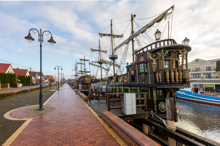 Leba, Pomorskie, Poland - December, 18, 2020: Port in a small town. Harbor wharf and boats moored to the shore. Autumn season.のeditorial素材