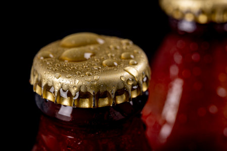 Metal wet cap on a dark glass bottle. A tasty drink closed with a cap. Dark background.の写真素材