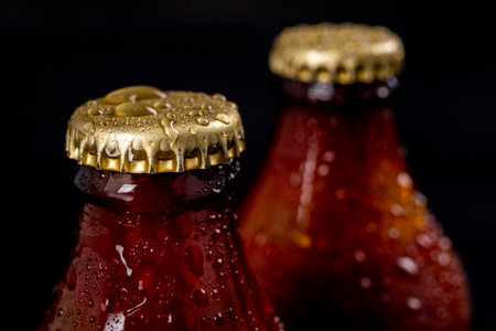 Metal wet cap on a dark glass bottle. A tasty drink closed with a cap. Dark background.の写真素材