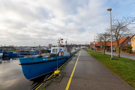 Leba, Pomorskie, Poland - December, 18, 2020: Port in a small town. Harbor wharf and boats moored to the shore. Autumn season.のeditorial素材
