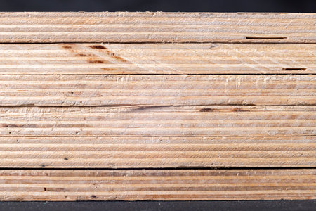 Stacked plywood boards. Materials for carpenters for the construction of furniture. Dark background.の写真素材