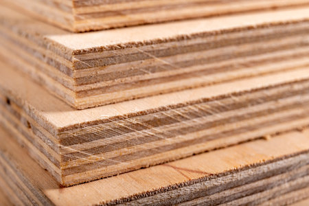 Plywood panels stacked on top of each other. Materials for carpenters for the construction of furniture. Dark background.の写真素材