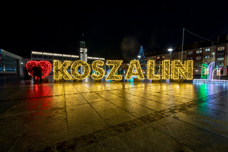 Koszalin, West Pomeranian Voivodeship Poland - December, 26, 2020: Christmas decorations in the market square of a small town. City center illuminated by street lamps. Autumn season.のeditorial素材