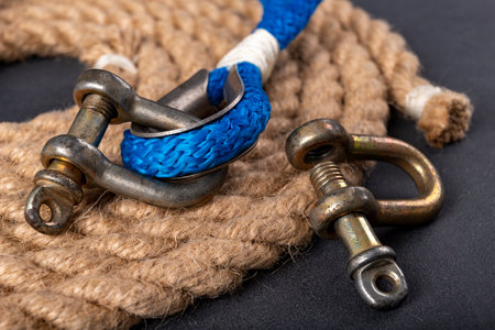 Shackle and rope on the table. Accessories for sea wolves on the table. Dark background.