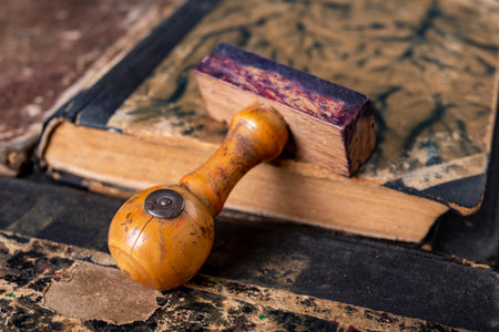 Wooden stamp for making stamps. Office accessories in the old office. Dark background.の写真素材