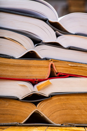 Pile of open books. A large amount of information contained in books. Dark background.の写真素材