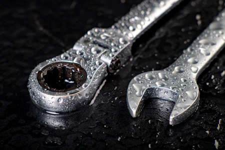 Water drops on workshop wrenches. Wet tools used in a machine shop. Cimen background.