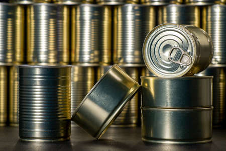 Metal cans with preserved meat. Food with a long shelf life. Dark background.の写真素材
