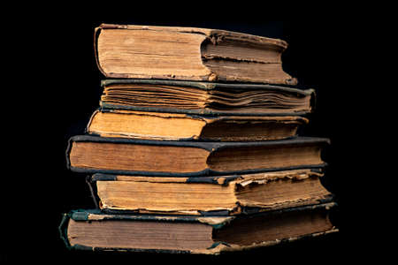 A stack of old books. Paper publications from the old library. Dark background.の写真素材
