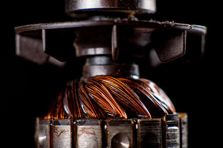 Rotor of a small electric motor. Spare parts in the electrical workshop. Dark background.の写真素材