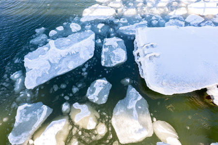 Floe floating on the sea. Frozen pieces of ice in the water. Winter season.の写真素材