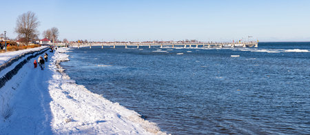 Mechelinki, Pomorskie Poland - February, 14, 2021: Pier and walking tourists. A place of rest in a small fishing village. Winter season.のeditorial素材