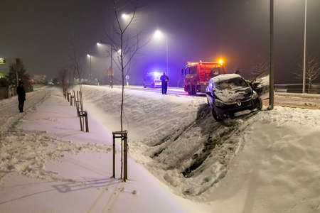 Czluchow, Pomeranian Voivodeship Poland - February, 17, 2021: Road accident during a blizzard. Rescue action of road services. Winter season.のeditorial素材