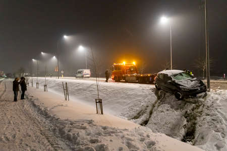 Czluchow, Pomeranian Voivodeship Poland - February, 17, 2021: Road accident during a blizzard. Rescue action of road services. Winter season.のeditorial素材