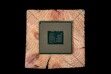 A personal computer processor stacked on raw wood. Accessories and spare parts for computer repair. Dark background.の写真素材