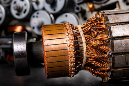 Small electric motors for driving domestic appliances. Electric devices stacked on a table. Dark background.の写真素材