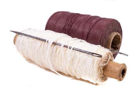 Strong twine and old heavy tailoring needles. Accessories used in a leathercraft workshop. Light background.の写真素材