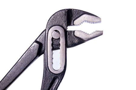 Adjustable wrench used in installation work. Accessories for plumbers. Light background.