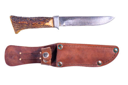 A hunting knife with a leather scabbard and a deer horn handle. Accessories for hunters hunting deer. Isolated background.の写真素材
