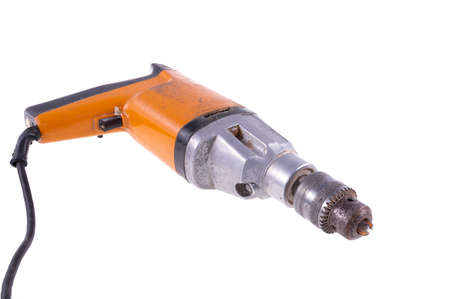 Old drill for making holes. Dirty and damaged tools for mechanics. Isolated background.の写真素材