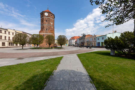 Znin, Kuyavian-Pomeranian Voivodeship Poland - April, 20, 2021: Market square and the old tower in the city center. Buildings and tenement houses in a small town. Spring season.のeditorial素材