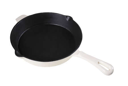 Empty massive heavy cast iron frying pan preparation for use. Accessories used in the home kitchen. Isolated background.の写真素材