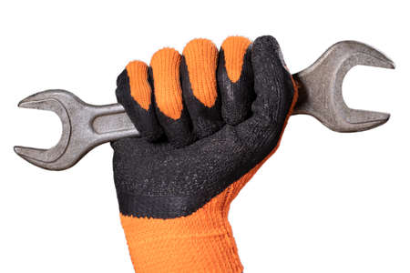 A metal flat wrench in the hand of a mechanic. Protective glove to protect against dirt in the workshop. Isolated background.の写真素材