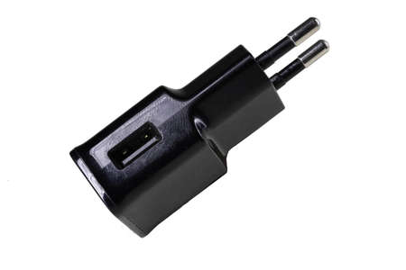 Wall charger for mobile phones. Electronic accessories for the operation of telecommunications devices. Isolated background.の写真素材