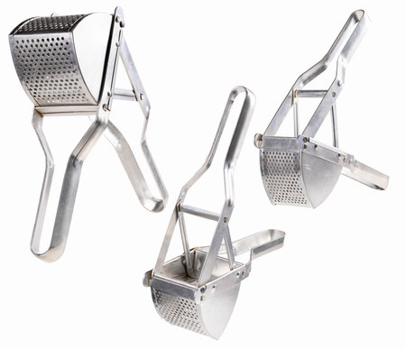 Metal press for crushing boiled potatoes. Accessories used in the home kitchen. Isolated background.の写真素材