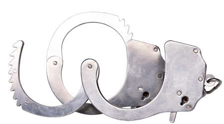 Metal handcuffs to restrain the hands of a criminal. Accessories for policemen working on the...