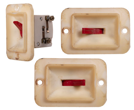 Old yellowed electrical switch used in household appliances.の写真素材