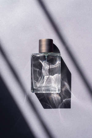 Natural light and geometric diagonal shadows. Beautiful sunshine. Clear glass and metal copper lid.の写真素材