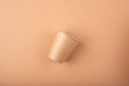 Eco friendly kitchen items . Zero waste and plastic free concept. Cup in top view on beige background. Disposable tableware. Natural products for recycle .の写真素材