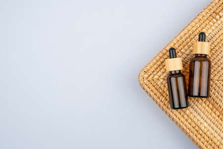 Eco friendly amber glass dropper bottle. Zero waste and plastic free concept on grey background. Skincare natural cosmetic concept for face body careの写真素材