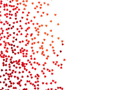 Red confetti in the form of hearts isolated on white background. Valentines day backdrop. Flat lay...