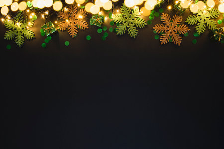 Christmas or New Year background with place for text. Green gift boxes and snowflakes on a black...