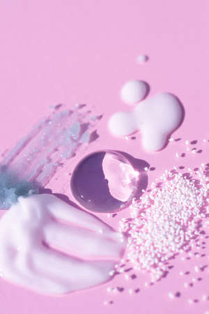 Cosmetic smears and drops in soft focus. Appearance of the texture of the cream, oil and granules on...
