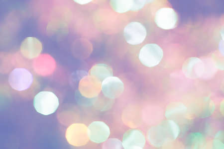 Beautiful natural bokeh of the colorful lights. Abstract Christmas New Year backdrop for text or advertising. Template for banner or party invitationの写真素材
