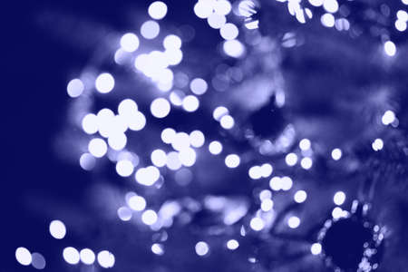 Christmas tree background with garland lights. New Year card with place for text. Festive decor...