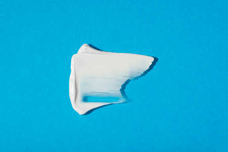 A smear of cream or face mask. The appearance of the texture of the cream on blue background. Skincare products , natural cosmetic. Beauty concept for face and body careの写真素材