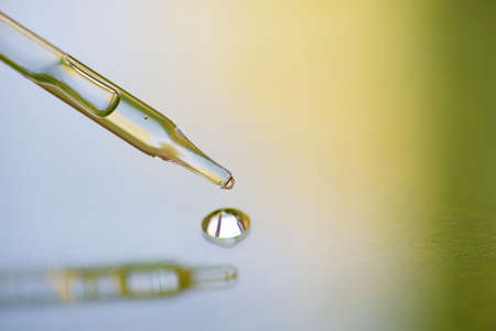 Pipette close-up on a light background in soft focus. Beautiful shadow in the sunlight. Skincare products , natural cosmetic. Beauty concept for face and body careの写真素材