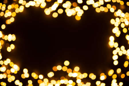 Beautiful natural bokeh of the yellow lights. Abstract Christmas New Year backdrop for text or...